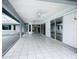 View of the tiled patio featuring ceiling fans and sliding glass doors leading to the pool and living areas at 7321 Teaberry St, Englewood, FL 34224