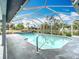 A beautiful screened-in pool featuring a stainless steel grab rail for easy access to the clear water at 7321 Teaberry St, Englewood, FL 34224