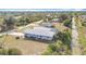 Charming single-story home featuring an enclosed porch and a well-maintained yard at 7321 Teaberry St, Englewood, FL 34224