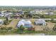 Aerial view of a single-story home with screened pool, lush greenery, and neighborhood at 7321 Teaberry St, Englewood, FL 34224