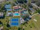 Aerial view showing tennis courts, pool, and clubhouse at 801 Waterside Dr # 102, Venice, FL 34285