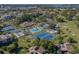 Aerial view of community amenities, including tennis courts and pool at 801 Waterside Dr # 102, Venice, FL 34285