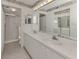 Bathroom with double vanity, large mirror, and shower at 801 Waterside Dr # 102, Venice, FL 34285