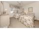 Bright bedroom with two twin beds, neutral carpet, and ceiling fan at 801 Waterside Dr # 102, Venice, FL 34285