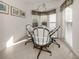 Sunlit breakfast nook featuring a round table, white chairs, and decorative accents at 801 Waterside Dr # 102, Venice, FL 34285