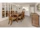 Traditional dining room with wood table and chairs, tile flooring, and mirrored wall at 801 Waterside Dr # 102, Venice, FL 34285