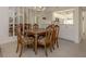 Traditional dining room with wood table and chairs, tile flooring, and mirrored wall at 801 Waterside Dr # 102, Venice, FL 34285