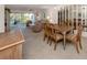Open dining area with wood table and chairs, overlooking the living room at 801 Waterside Dr # 102, Venice, FL 34285