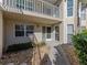 Exterior view of condo building with walkway, landscaping, and private entrance at 801 Waterside Dr # 102, Venice, FL 34285