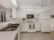 Clean and bright kitchen with white cabinets and modern appliances at 801 Waterside Dr # 102, Venice, FL 34285