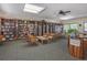 Community library with bookshelves and comfortable seating at 801 Waterside Dr # 102, Venice, FL 34285