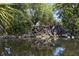 Serene waterfall feature with lush landscaping and pond at 801 Waterside Dr # 102, Venice, FL 34285