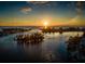 Aerial view of a sunset over the water at 826 Bayport Cir, Venice, FL 34292