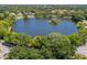 Bird's-eye view of a community lake surrounded by homes at 826 Bayport Cir, Venice, FL 34292