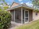 Backyard view showing screened porch and lawn at 826 Bayport Cir, Venice, FL 34292
