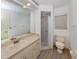 Clean bathroom with shower stall, toilet and vanity at 826 Bayport Cir, Venice, FL 34292
