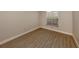 Simple bedroom with wood-look flooring and window at 826 Bayport Cir, Venice, FL 34292