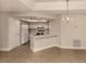 Bright kitchen features white cabinets, laminate flooring, and a breakfast bar at 826 Bayport Cir, Venice, FL 34292
