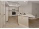 Bright kitchen features white cabinets, laminate flooring, and a breakfast bar at 826 Bayport Cir, Venice, FL 34292