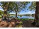 Serene lakeside bench nestled under the shade of trees at 826 Bayport Cir, Venice, FL 34292