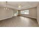 Spacious living room with vinyl plank flooring and sliding glass doors to patio at 826 Bayport Cir, Venice, FL 34292