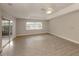 Spacious living room with vinyl plank flooring and sliding glass doors to patio at 826 Bayport Cir, Venice, FL 34292