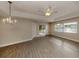 Spacious living room with vinyl plank flooring and sliding glass doors to patio at 826 Bayport Cir, Venice, FL 34292