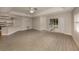 Bright living room with vinyl plank flooring, kitchen bar, and access to patio at 826 Bayport Cir, Venice, FL 34292