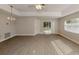 Spacious living room with vinyl plank flooring and sliding glass doors to patio at 826 Bayport Cir, Venice, FL 34292