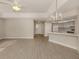 Bright living room with vinyl plank flooring, kitchen bar, and access to patio at 826 Bayport Cir, Venice, FL 34292