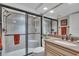 Updated bathroom with a walk-in shower and granite vanity at 840 The Esplanade N # 703, Venice, FL 34285