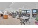 Bright community room with tables, chairs, and a kitchenette at 840 The Esplanade N # 703, Venice, FL 34285