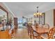 Condo dining room with wood table and view to living room at 840 The Esplanade N # 703, Venice, FL 34285