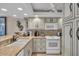 Kitchen with white cabinets, granite counters, and appliances at 840 The Esplanade N # 703, Venice, FL 34285
