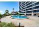 Community pool with plenty of lounge chairs at 840 The Esplanade N # 703, Venice, FL 34285