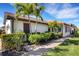 Beautiful home exterior with manicured landscaping and a brick pathway at 9824 Haze Dr, Venice, FL 34292