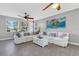 Living room with white couch and large ocean art at 9824 Haze Dr, Venice, FL 34292