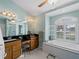 Bathroom with soaking tub, double vanity, and large mirror at 1035 Beckley Cir, Venice, FL 34292