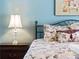 Bedroom with floral bedding and wood nightstand at 1035 Beckley Cir, Venice, FL 34292