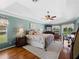 Spacious Primary bedroom with wood floors and backyard view at 1035 Beckley Cir, Venice, FL 34292