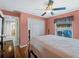 Bright bedroom with double doors leading to the ensuite bathroom at 1035 Beckley Cir, Venice, FL 34292