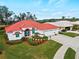 Single-story home with red tile roof, white walls, and a two-car garage at 1035 Beckley Cir, Venice, FL 34292