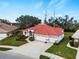 Single-story house with red tile roof, white walls, and a two-car garage at 1035 Beckley Cir, Venice, FL 34292