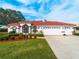 Single-story home with red tile roof, white walls, and a two-car garage at 1035 Beckley Cir, Venice, FL 34292