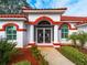 Front entrance with decorative screen door and red accents at 1035 Beckley Cir, Venice, FL 34292