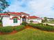White house with red tile roof and manicured lawn at 1035 Beckley Cir, Venice, FL 34292