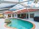 Inviting pool area with screened enclosure and lounge chairs at 1035 Beckley Cir, Venice, FL 34292