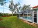 Screened pool and surrounding grassy yard at 1035 Beckley Cir, Venice, FL 34292