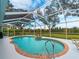 Relaxing kidney-shaped pool with a covered patio area at 1035 Beckley Cir, Venice, FL 34292