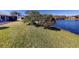 Large grassy backyard leading to a lake at 104 Woodingham Dr, Venice, FL 34292